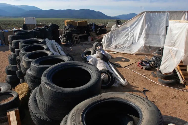 FILE - In this Aug. 10, 2018, file photo, a makeshift living compound in Amalia, N.M., is shown. The five men and women found living in a ramshackle compound in northern New Mexico where a boy was found dead last year have been indicted on federal charges related to terrorism, kidnapping, and firearms violations. The U.S. Attorney's Office in New Mexico announced the superseding indictment Thursday, March 14, 2019.