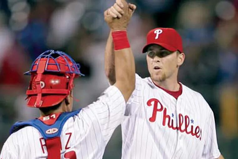 Phillies' pitcher Brade Lidge and catcher Carlos Ruiz celebrate their win over the Cincinnati Reds on Tuesday.  The Phillies beat the Reds, 3-2.  (Yong Kim / Philadelphia Daily News)
