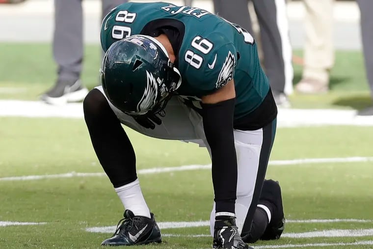 Eagles tight end Zach Ertz takes a knee after getting hurt during the fourth quarter against the Baltimore Ravens on Sunday.