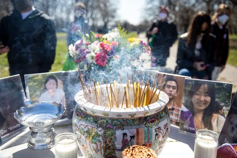 People light incense as they give prayers and blessings to the victims of the Atlanta spa shootings during the Stop Anti Asian Hate Vigil at FDR Park on Saturday, April 3, 2021.