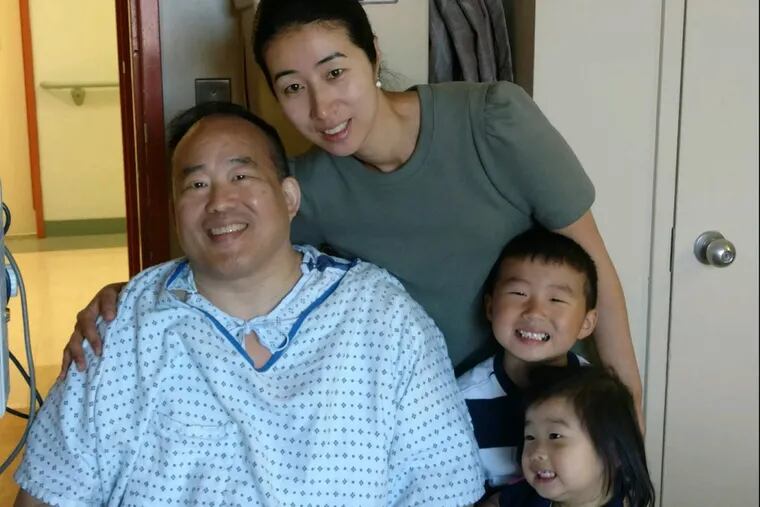 Philadelphia City Councilman David Oh is shown as he was  recuperating at Penn Presbyterian Medical Center in Philadelphia after he was stabbed near his home May 31, 2017, in an attempted robbery. With him are his wife, Heesun; their son, Daniel, and daughter, Sarah.