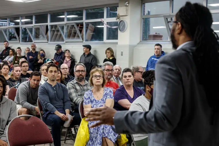 Councilperson Jeffrey Young Jr, answers questions from Fairmount residents about the homeless services center at 2100 W. Girard Ave. Tuesday, May 14, 2024