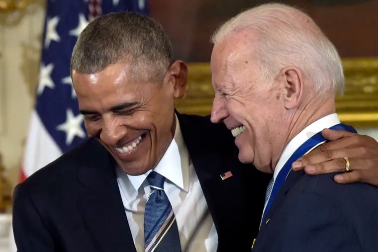President Barack Obama laughs with Vice President Joe Biden during a 2017 ceremony in the State Dining Room of the White House, where Obama presented Biden with the Presidential Medal of Freedom.
