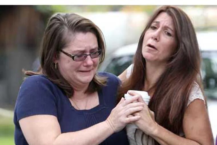 Denise Spadafora (left), aunt of Autumn Pasquale, is comforted by Donna Ciambrano after learning of the discovery of the girl's bicycle. Another relative, Paul Spadafora, said: "Keep the family in your prayers." (Charles Fox / Staff Photographer)