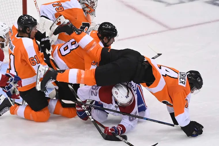 This collision of Flyers and Canadiens players during the second period might sum up Flyers fans' frustration.