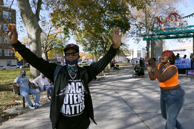 A man wears a shirt that says, "Black voters matter," while dancing Sunday in Fairhill Square Park in Philadelphia, to celebrate after Democrat Joe Biden defeated President Donald Trump to become 46th president of the United States.