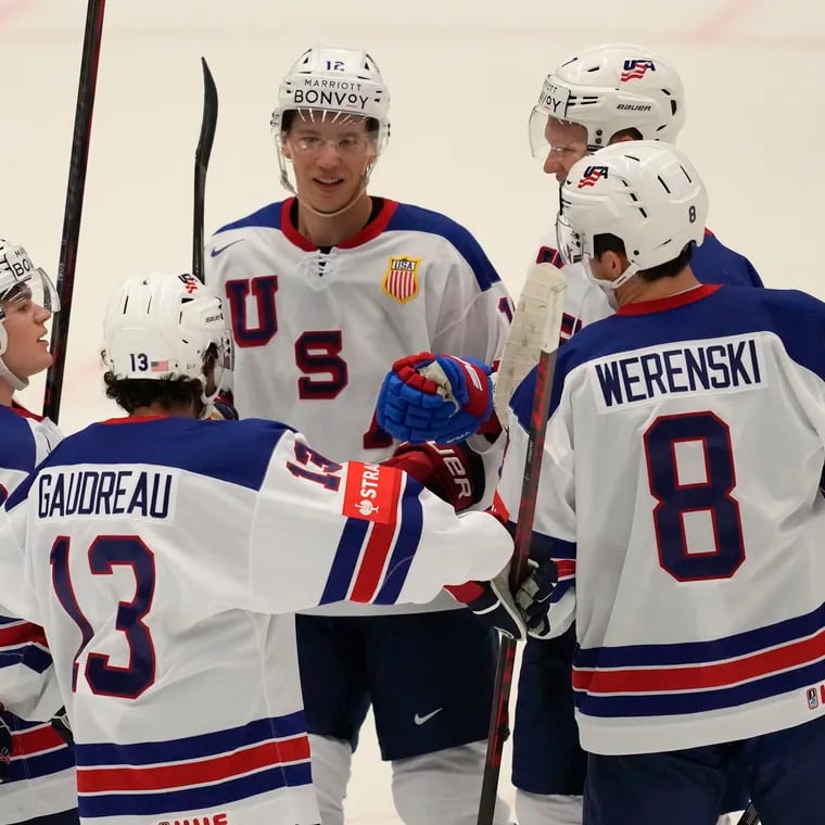 The United States' Brady Tkachuk celebrates with Johnny Gaudreau and teammates after scoring his side's fourth goal against Kazakhstan.