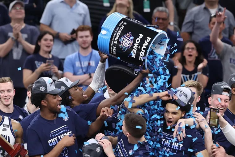 Villanova players dump a cooler of confetti on each other celebrating getting to the Final Four.