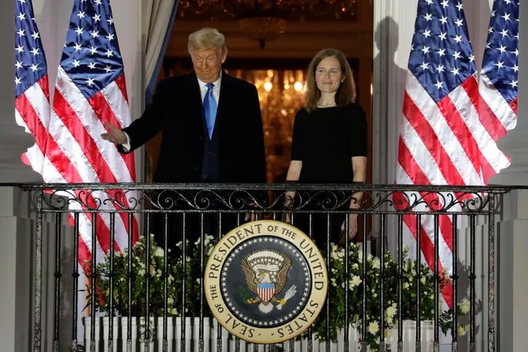 U.S. President Donald Trump appears with new Supreme Court Associate Justice Judge Amy Coney Barrett after she was sworn in during a ceremony on the South Lawn of the White House in Washington, D.C. on Oct. 26, 2020. (Yuri Gripas/Abaca Press/TNS)