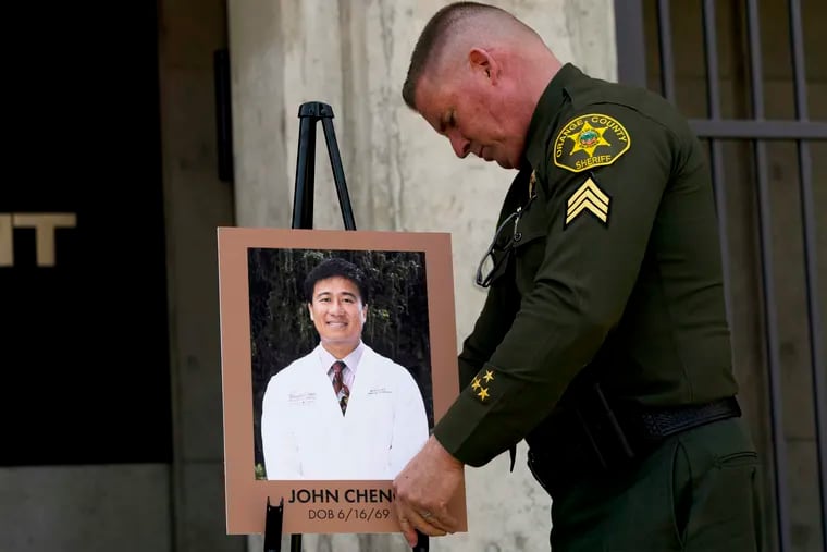 Orange County Sheriff's Sgt. Scott Steinle displays a photo of Dr. John Cheng, a 52-year-old victim who was killed in Sunday's shooting at Geneva Presbyterian Church, during a news conference in Santa Ana, Calif., Monday, May 16, 2022.