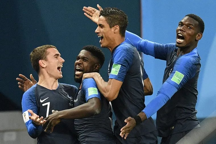 France's Samuel Umtiti, second from left, is congratulated by his teammates France's Antoine Griezmann, Raphael Varane and Paul Pogba, from left, after scoring the opening goal during the semifinal match between France and Belgium at the 2018 soccer World Cup in the St. Petersburg Stadium in St. Petersburg, Russia, Tuesday, July 10, 2018.