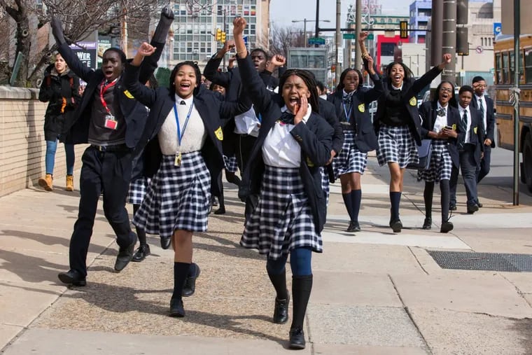 Kayla Brooks, center, from the Multicultural Academy Charter School in Philadelphia, walks with other students on the one-month anniversary of the Parkland, Fla., high school shooting that killed 17 people.