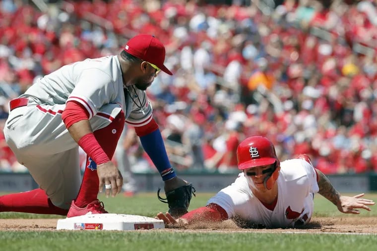 Carlos Santana can’t get the tag on the Cardinals’ Tyler O’Neill in time during the fourth inning of the Phillies loss in St. Louis on Sunday.
