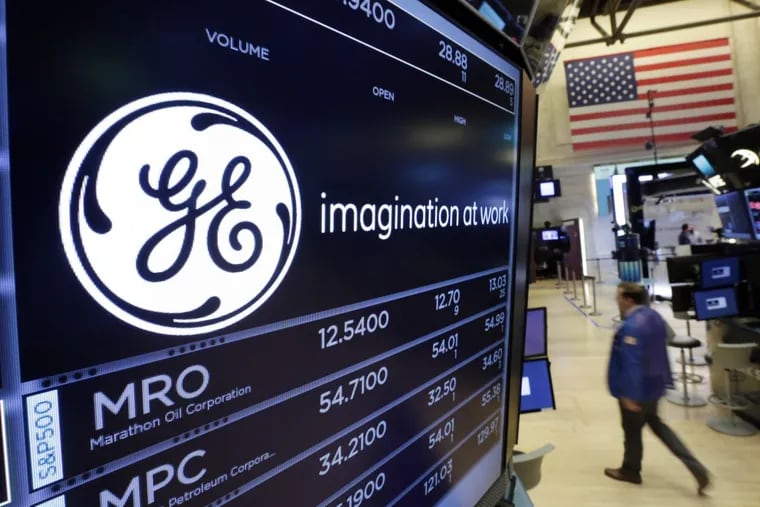 The GE logo appears above a trading post on the floor of the New York Stock Exchange, Monday, June 12, 2017. General Electric says CEO John Flannery will announce his plan for the company Monday .