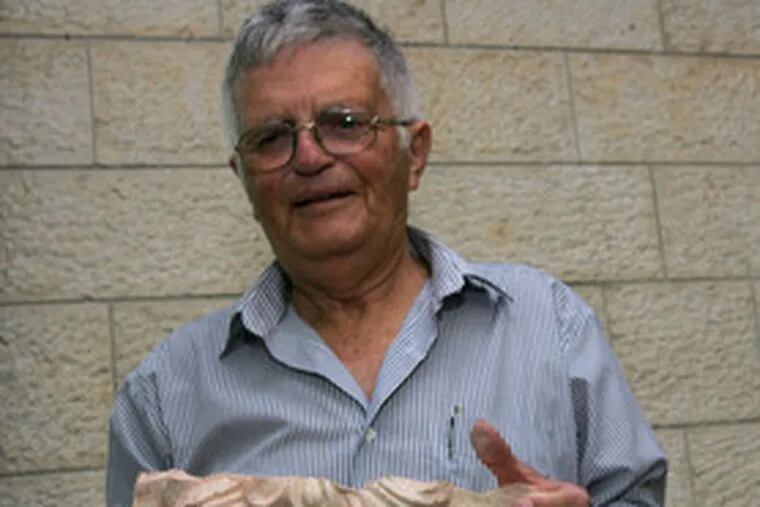 Ehud Netzer with a piece of carved stone from what could be Herod&#0039;s sarcophagus. So far, no body or written confirmation has been found.