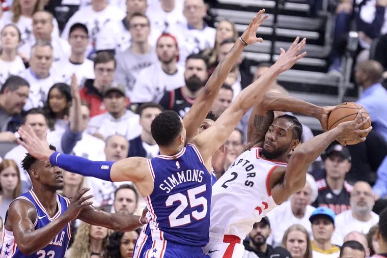 Ben Simmons and Jimmy Butler converge on the Raptors' Kawhi Leonard in Game 2.
