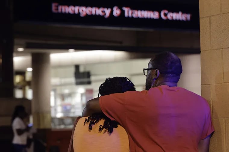 Friends and family of South Street shooting victims gather outside Thomas Jefferson University Hospital Emergency Department early Sunday morning. (Elizabeth Robertson/Staff Photographer)