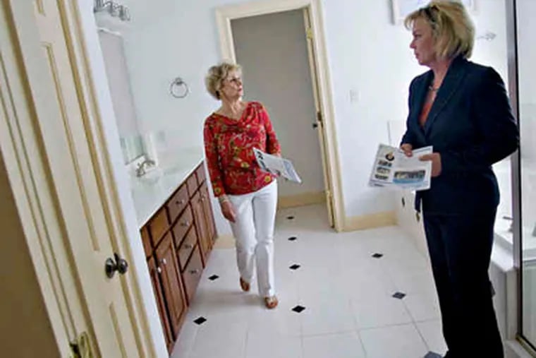Real estate broker Shelley Mitchiner (right) shows Sharon Willard an existing home for sale in Raleigh, N.C. (Jim R. Bounds / Bloomberg)