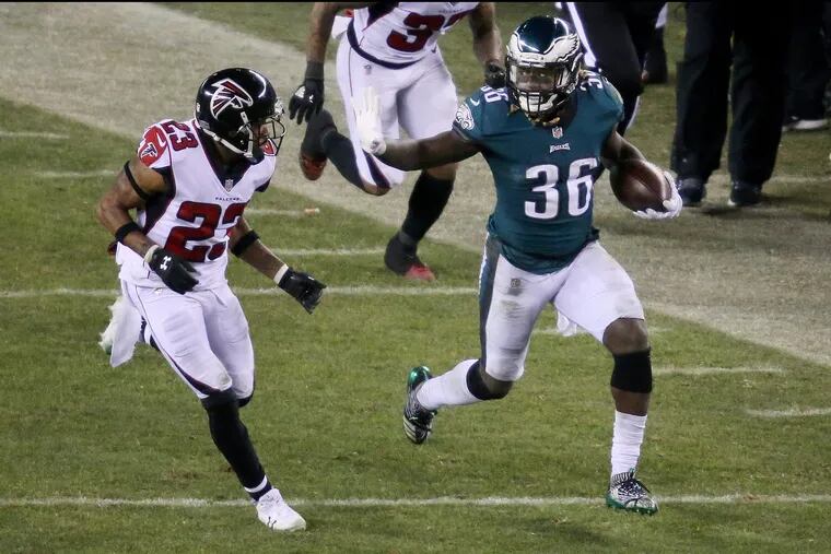 Eagles running back Jay Ajayi fending off Falcons cornerback Robert Alford (23) during the second half of the teams' playoff game in January.