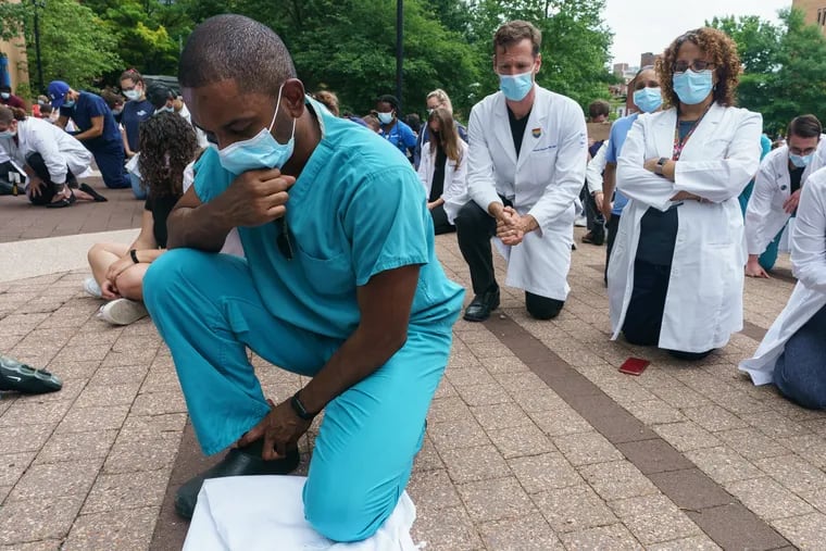 Medical staff at a demonstration to draw attention to systemic racism during a "White Coats for Black Lives" demonstration at Lubert Plaza at 10th and Locust Streets during the seventh day of protests over the death of George Floyd in Minneapolis.