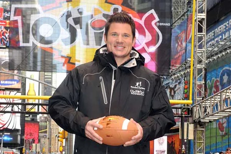 In this file photo, Nick Lachey kicks-off "Tostitos Fiesta in the Square" celebration Friday, Dec. 16, 2011, in New York's Times Square. He hosts NBC's new game show. (Diane Bondareff/AP Images for Tostitos)
