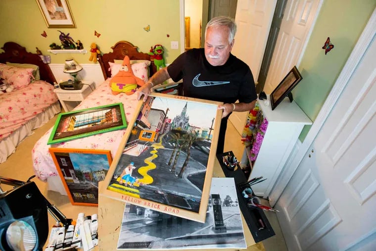 Paul Galiczynski, shown here holding his painting "Yellow Brick Road" among other works in his studio space, that doubles as his grandaughters room, in his Washington Crossing home, Wednesday, Aug. 2, 2017. Galiczynski paints contemporary city scapes of Philadelphia, he is inspired by scenes he sees when driving from job to job through the streets of Philadelphia.
