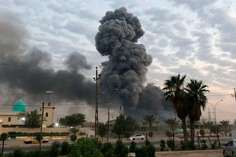 FILE - In this Monday, Aug. 12, 2019 file photo, plumes of smoke rise after an explosion at a military base southwest of Baghdad, Iraq. A fact-finding committee appointed by the Iraqi government to investigate a massive munitions depot explosion near the capital Baghdad has concluded that the blast was the result of a drone strike. A copy of the report was obtained by The Associated Press Wednesday, Aug. 21, 2019.