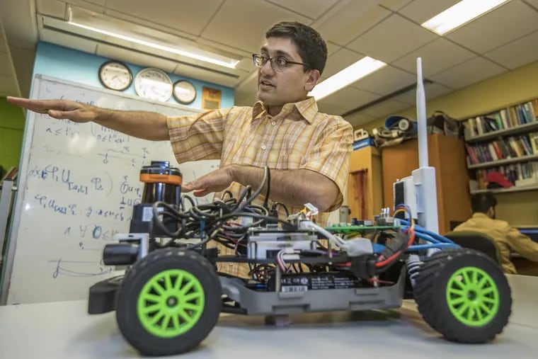 Engineering professor Rahul Mangharam talks about self-driving cars while his F1 Tenth sits right in front of him in his lab at Penn Engineering. The F1 Tenth is 1/10th the size of a Formula One car and it contains self-driving algorithms.