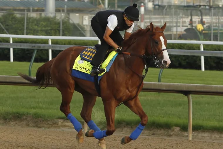 Justify, shown here with exercise rider Humberto Gomez, is a heavy favorite to win Saturday's Belmont Stakes, which would give him the Triple Crown. 