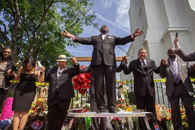 At a service outside the Emanuel AME Church in Charleston, S.C., on Saturday, clergy from around the country led prayers. STEPHEN B. MORTON / Associated Press
