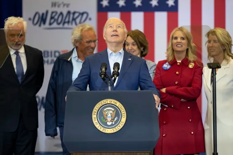 Surrounded by members of the Kennedy family, President Joe Biden speaks at the Martin Luther King Jr. Recreation Center in Philadelphia on Thursday, with the Pennsylvania primary five days away.