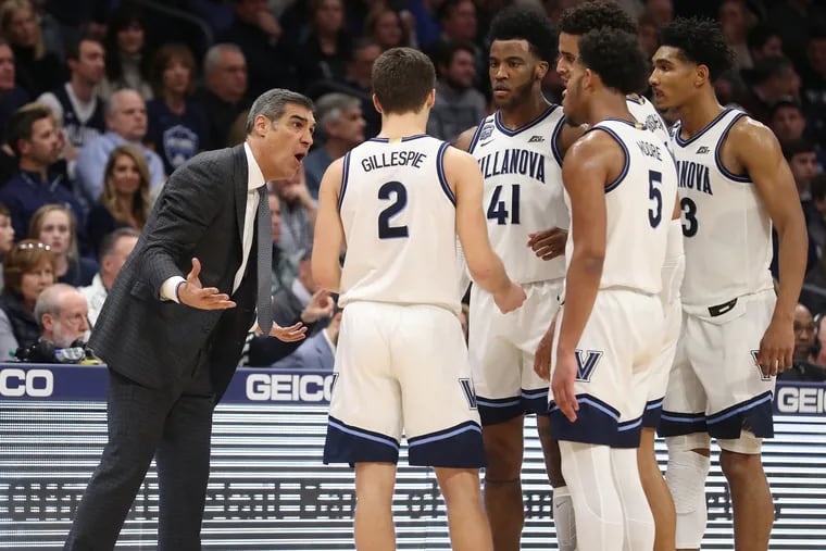 Villanova coach Jay Wright, left, talks to his players late in the game against Marquette on Feb. 12 at the Finneran Pavilion.