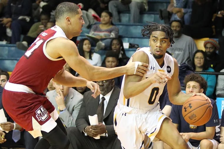 Pookie Powell (right), driving against Randall West of UMass, leads the Explorers in points and minutes.