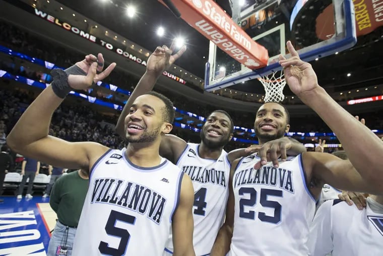 Phil Booth (left), Eric Paschall, and Mikal Bridges celebrate a win last March. Bridges is gone, but Booth and Paschall return to a top-10 ranked Villanova team.