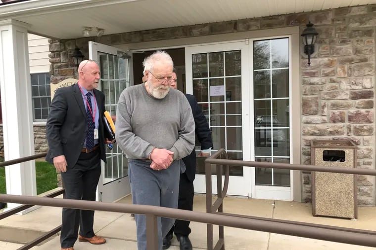William Korzon, 78, is escorted out of district court in Jamison after his arraignment on Thursday. He's accused of murdering his wife, Gloria, in 1981.