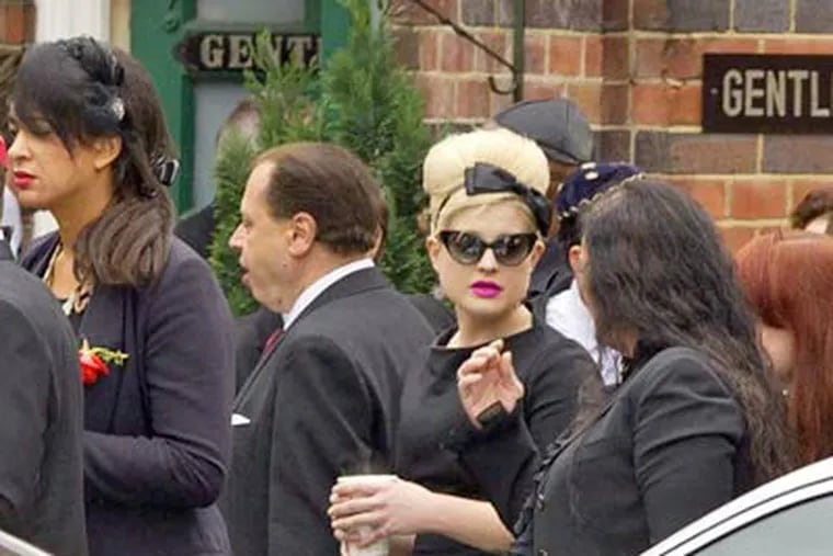 Kelly Osbourne wears her hair in a beehive, with black bow, as a tribute to her good friend, singer Amy Winehouse, who was laid to rest on Tuesday. She died Saturday at the age of 20.
