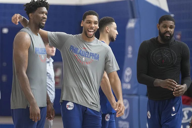 Joel Embiid (left) and Jahlil Okafor (center share a laugh during practice. Amir Johnson and Ben Simmons are also shown.