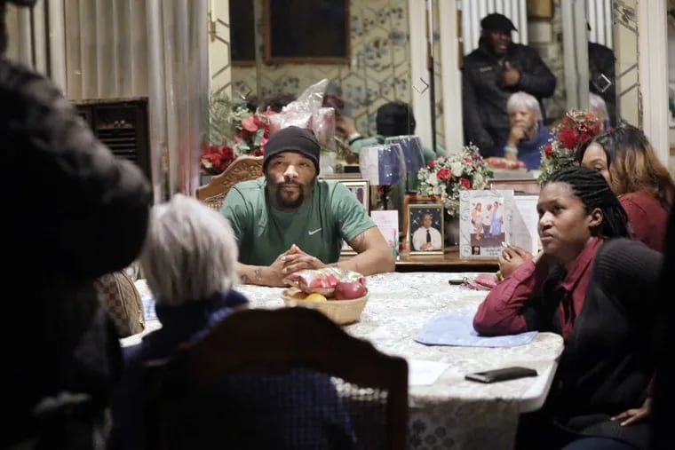 James Cade (left, seated) nephew of Kevin Brinkley and LaToya Berry (right, seated) Brinkley&#039;s daughter, listen during a family meeting in February.