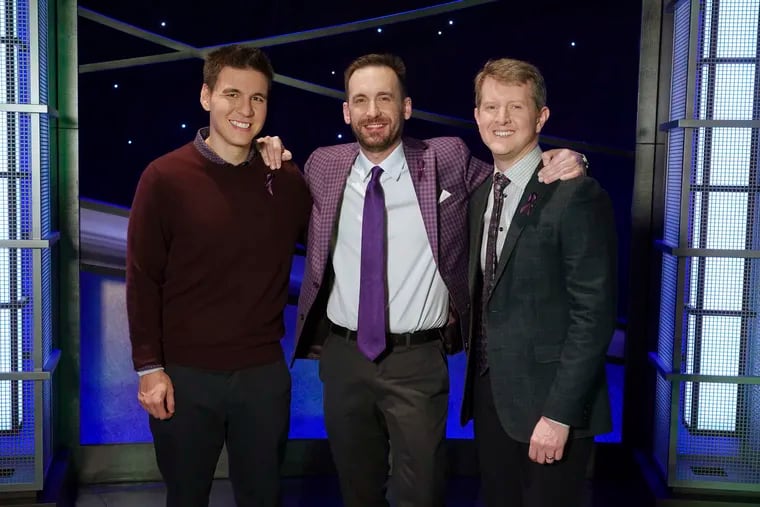 In this image released by ABC, contestants, from left, James Holzhauer, Brad Rutter and Ken Jennings appear on the set of "Jeopardy!" in Los Angeles. The all-time top money winners; Rutter, Jennings and Holzhauer, will compete in a rare prime-time edition of the TV quiz show "Jeopardy! The Greatest of All Time," which will air on consecutive nights beginning 8 p.m. EDT Tuesday. (Eric McCandless/ABC via AP)