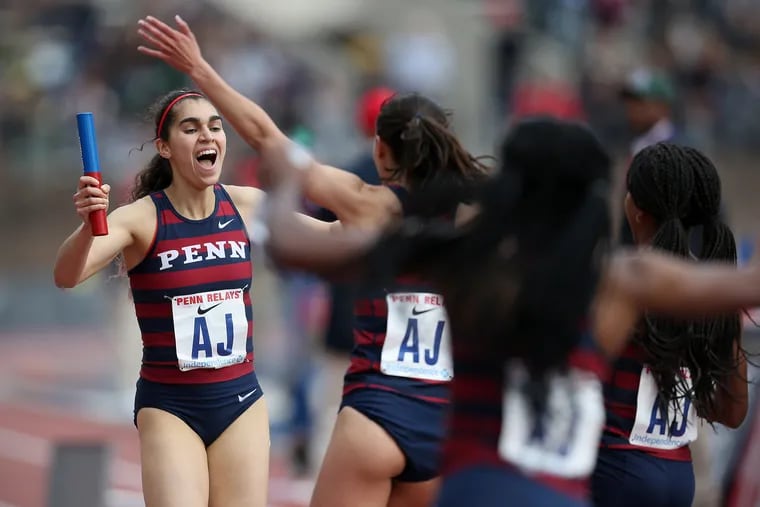 Penn's Maddie Villalba, left, celebrates with her teammates after crossing the finish line in the college women's distance medley championship during the 125th annual Penn Relays at Franklin Field in Philadelphia on Thursday, April 25, 2019. Penn won the event, setting a new Ivy League record.