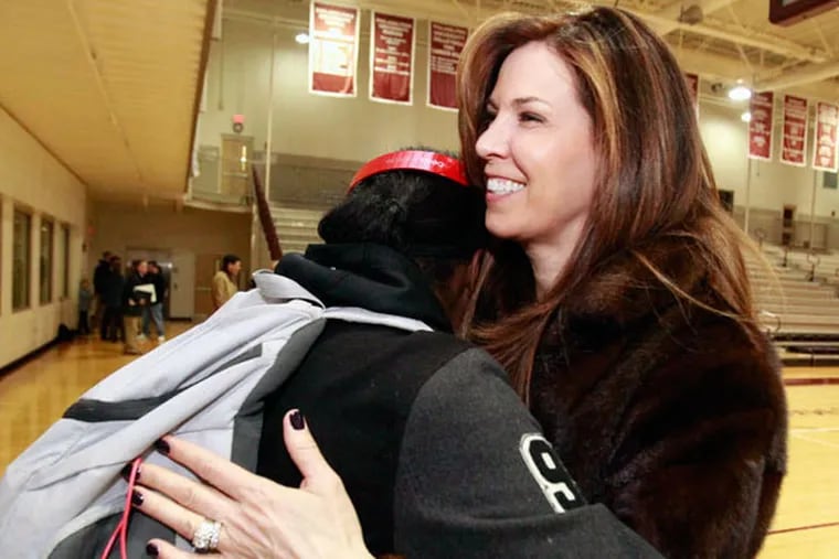 Former coach Letitia Santarelli hugs Alisha Kebbe. Santarelli was dismissed in November and has filed a libel-slander suit.