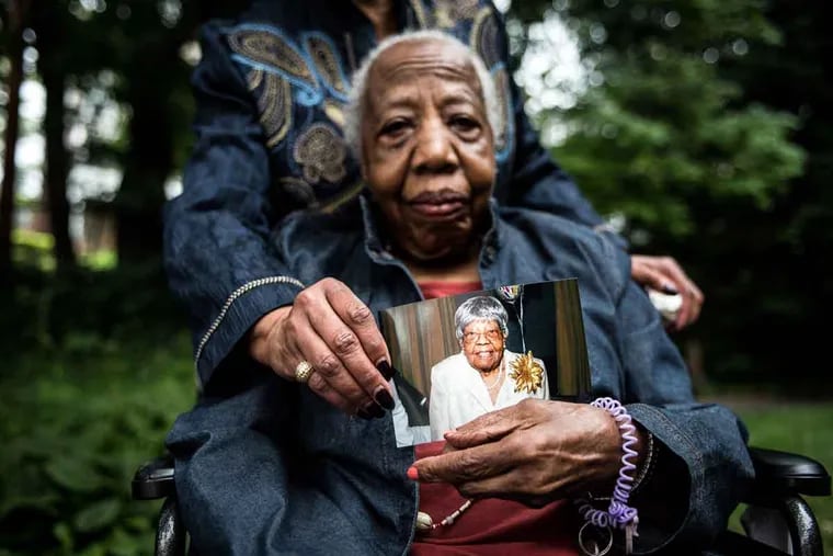 Bessie Williams will celebrate her 100th birthday on Sunday. She is holding a photo of her sister Othie Rowser, who reached her centennial in 2014.