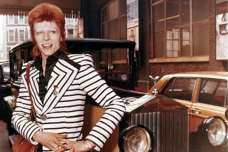 British rock singer, David Bowie, poses beside his Rolls Royce in May 1973.