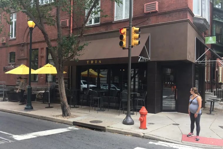 Owners of Tria are among the restaurateurs troubled by pending changes to the way they purchase wine through the Pennsylvania Liquor Control Board. Here, at the Tria location at 12th and Spruce Streets in Center City, on Monday morning an employee readies the place for lunch.