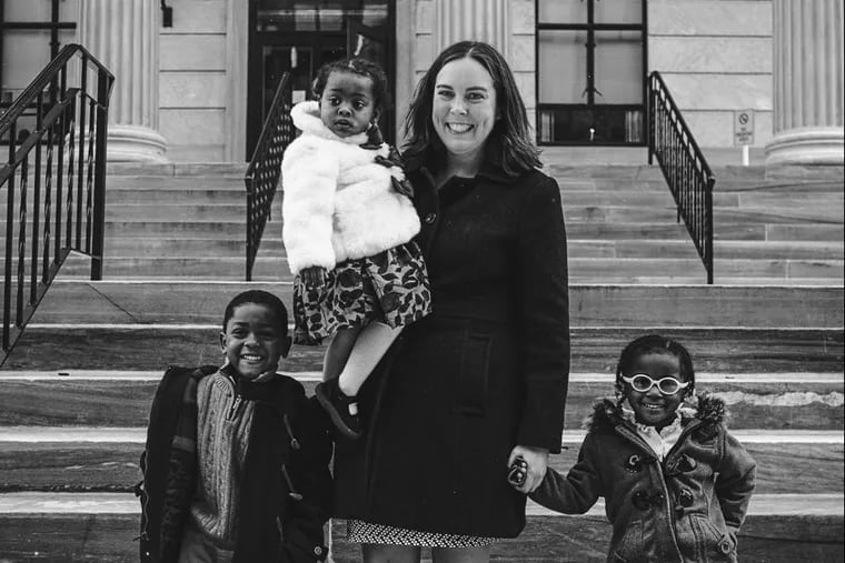 Kim Clemens with her children: Sudan (left), Tunisia (right) and Mali (in her arms).