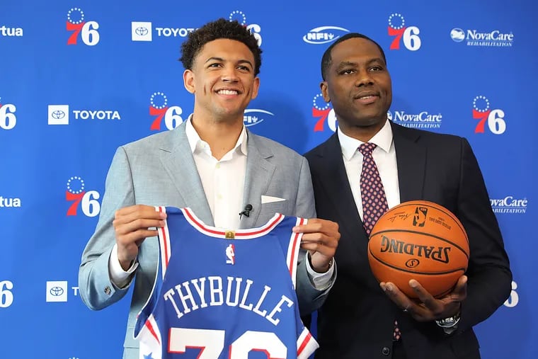 Sixers GM Elton Brand poses for a photo with first-round pick Matisse Thybulle (left) at Thybulle's introductory press conference.