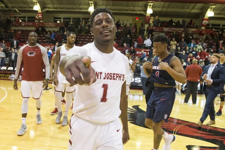 Shavar Newkirk of St. Joseph's celebrates after their victory over Duquesne at Hagan Arena on Feb. 17, 2018. CHARLES FOX / Staff Photographer