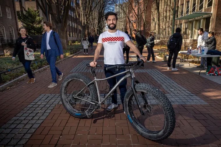Ryan Torres, a sophomore at Wharton, poses on Penn's Locust Walk with the bike he used to climb Ojos del Salado, a volcano on the Argentina-Chile border that has the distinction of being the highest volcano in the world.