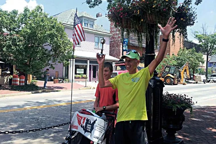 Father and son, Brett and David Wilcox, pose for pictures in Collingswood after running from the Liberty Bell in Philadelphia, over the Ben Franklin bridge and through Camden. The two are running to Ocean City from the Los Angeles area to raise awareness of GMO labelling.