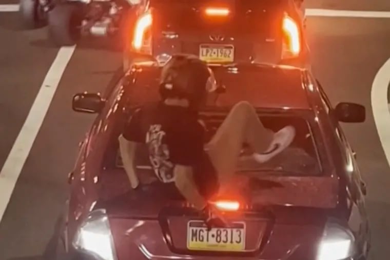 This image provided by George Coloney/@Vortex.hz shows a shows a biker smashing a car’s back window on Oct. 1 in Philadelphia. According to authorities, the biker, Cody Heron, pleaded guilty to aggravated assault and a weapons charge. He faces sentencing in June.